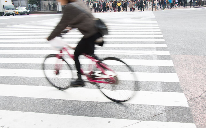 bicyclist riding through cross walk