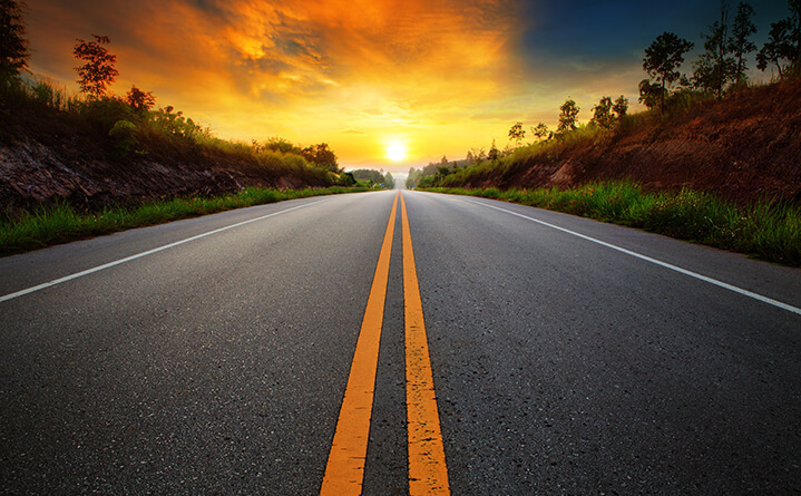 sunset on road with motorcycle