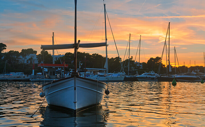 boat in harbor at sunset